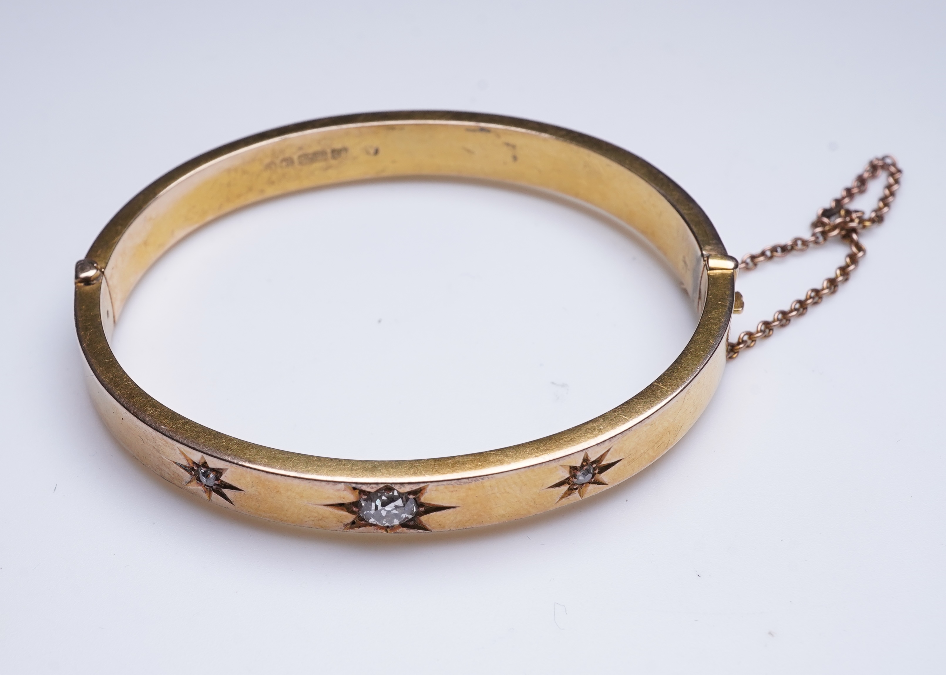 An Edwardian 15ct gold and diamond bangle, circa 1904